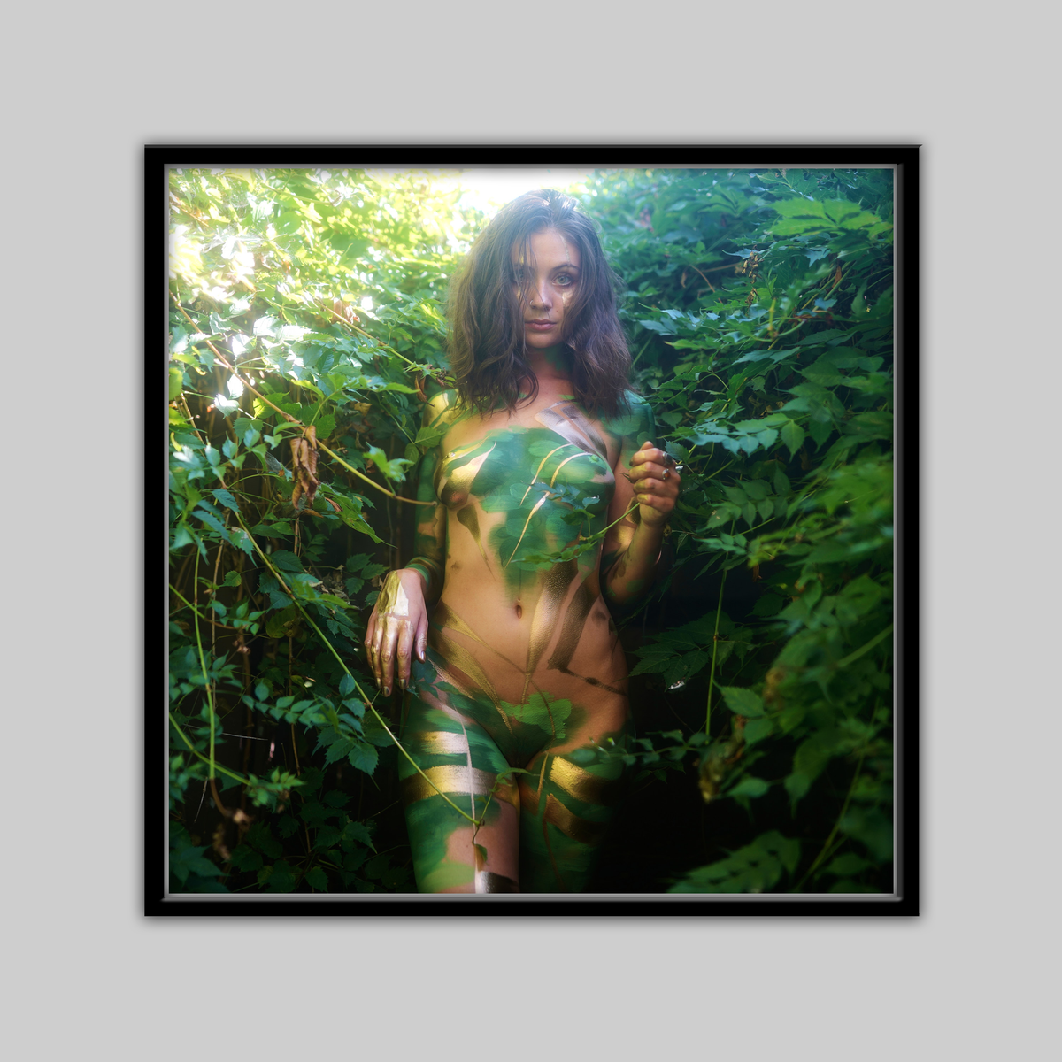 Print: My Secret Garden by Paul Roustan, nude woman with gold body paint amid green foliage.